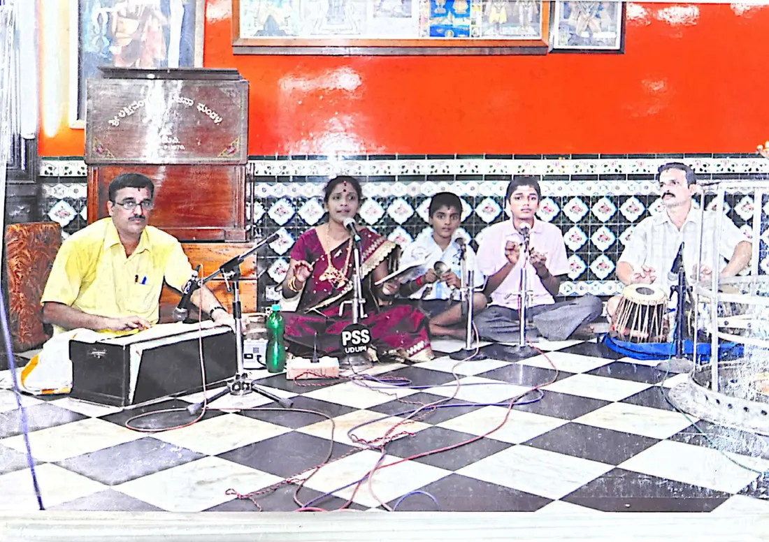 A vocal recital with harmonium, violin and tabla accompaniment at a temple hall