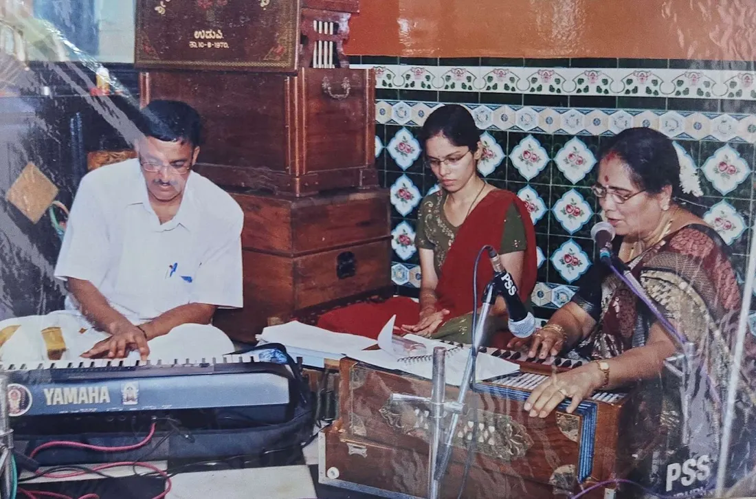 Musicians performing with keyboard and harmonium